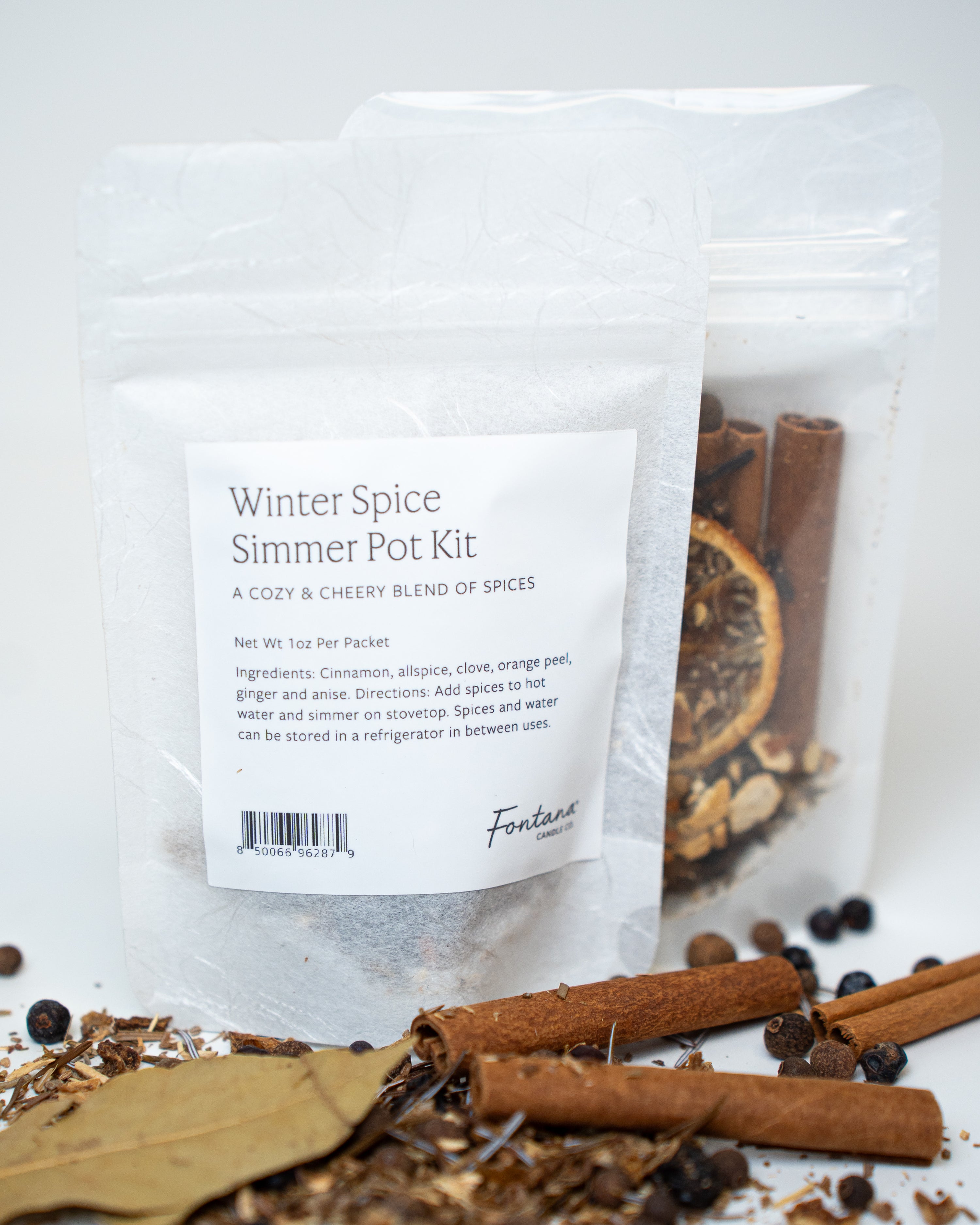 Winter Spice Simmer Pot Kit with packaging on a white background, surrounded by cinnamon and spices.
