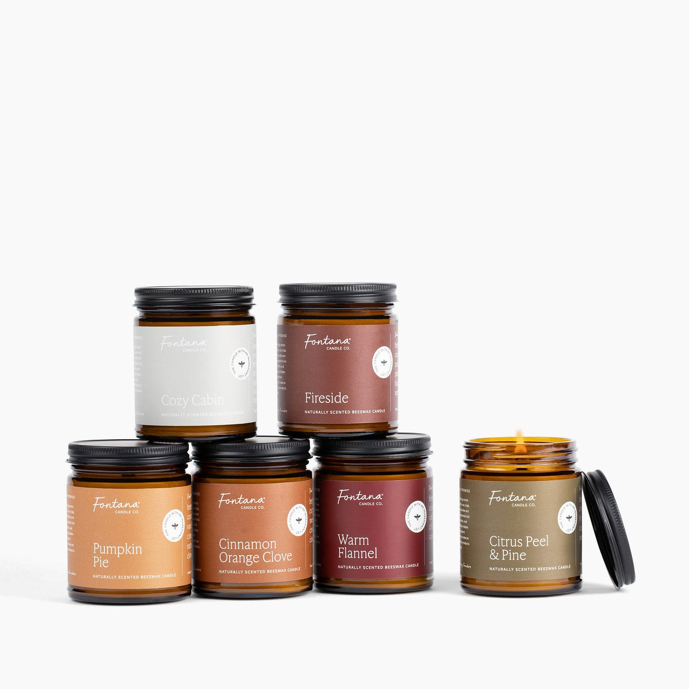 Collection of Fontana candles Pumpkin pie, Cozy Cabin, Cinnamon Orange Clove, Fireside, Warm Flannel and Citrus Peel &amp; Pine on a white background