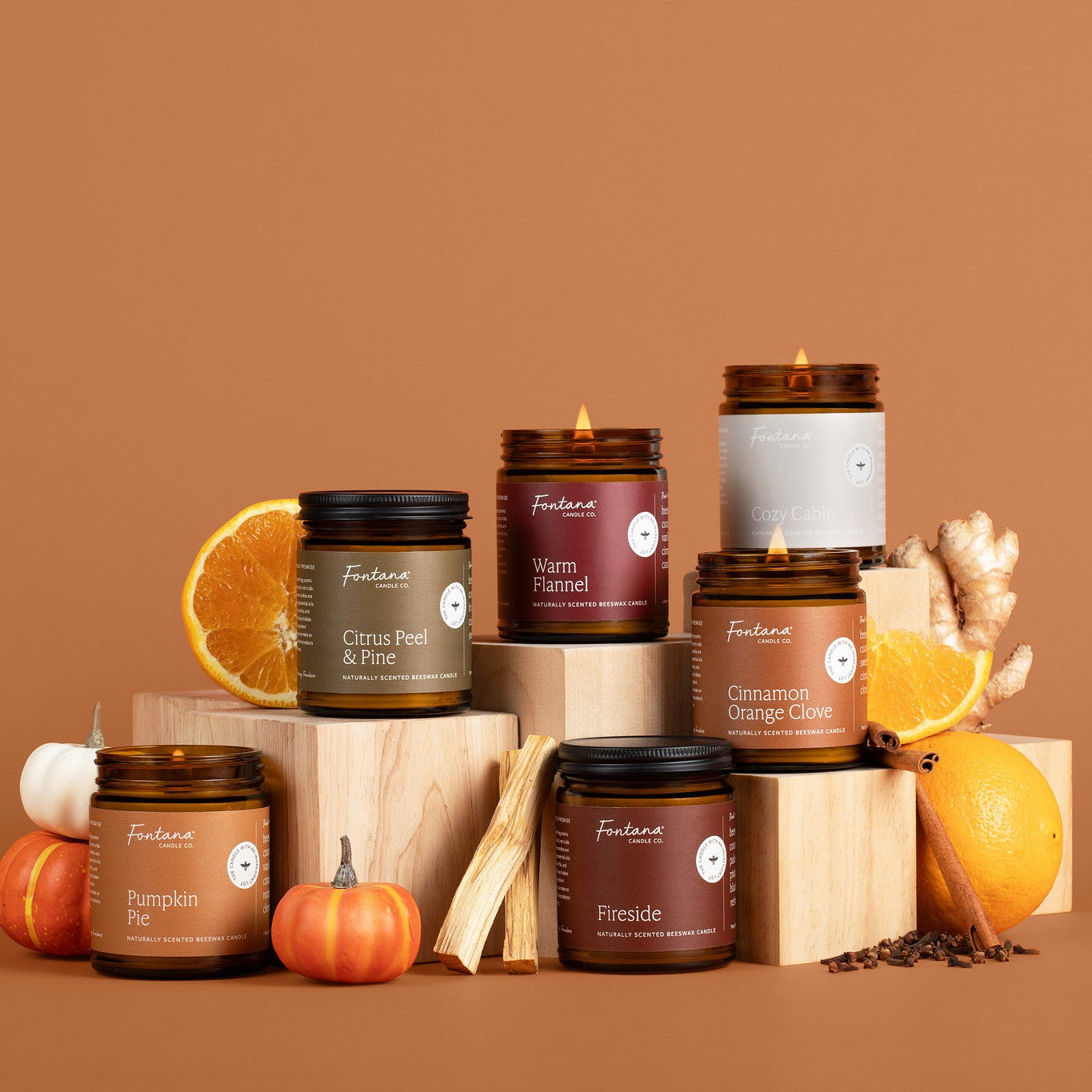 Collection of candles and decorative items on a brown background