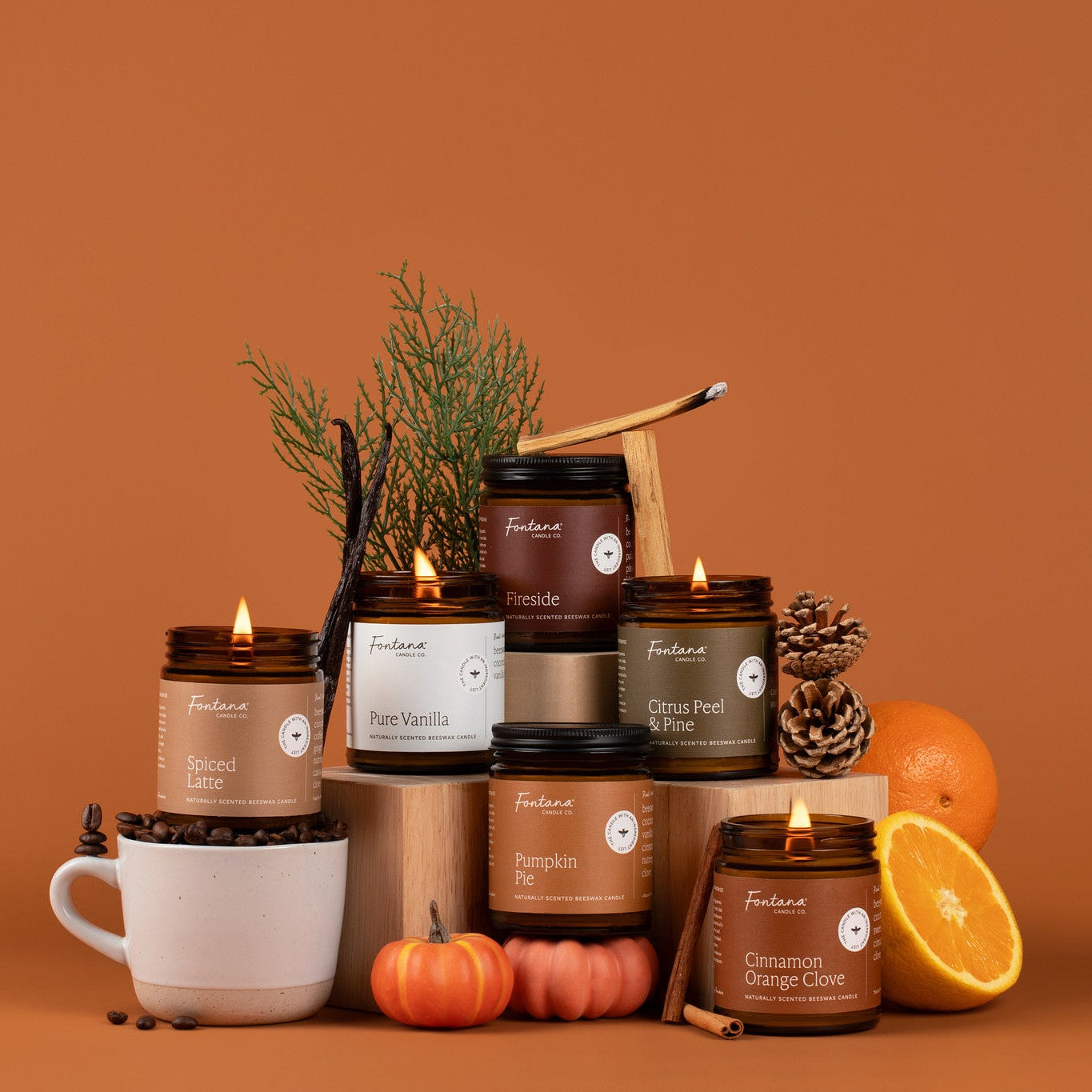 Collection of candles and decorative items on a orange background