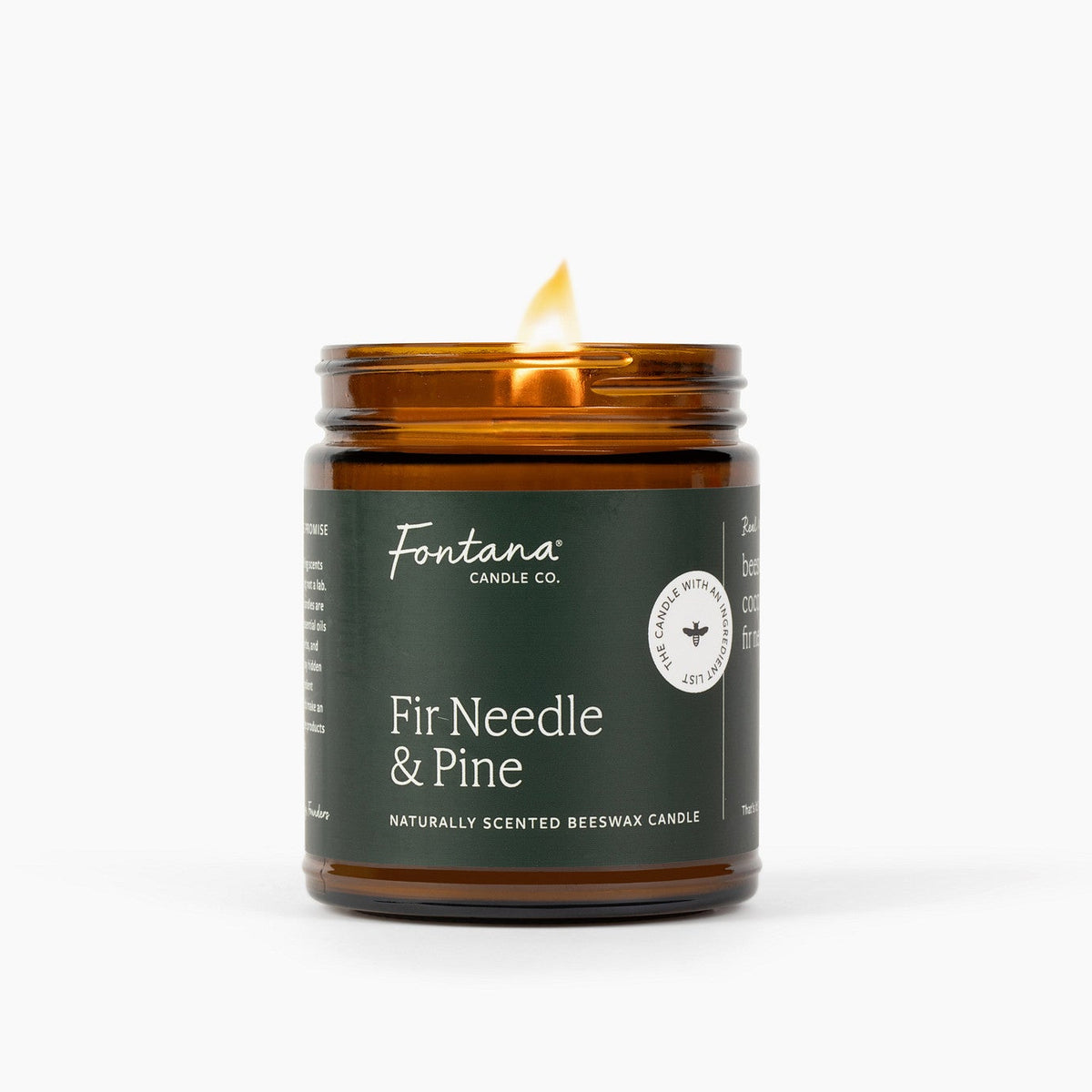An amber glass jar candle with a lit wick, featuring a dark brown label that reads 'Fontana Candle Co. Fir Needle &amp; Pine' on a clean white background.