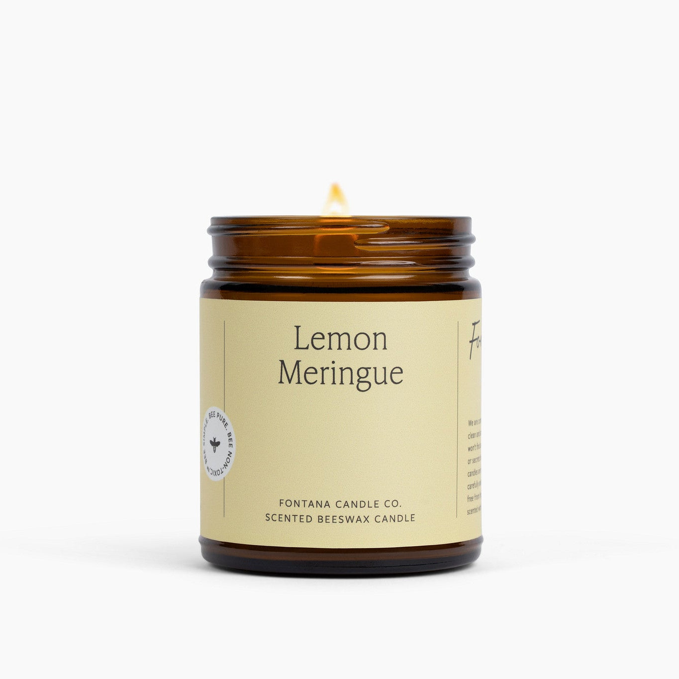Lemon Meringue yellow labeled candle with a brown glass jar on a white background.