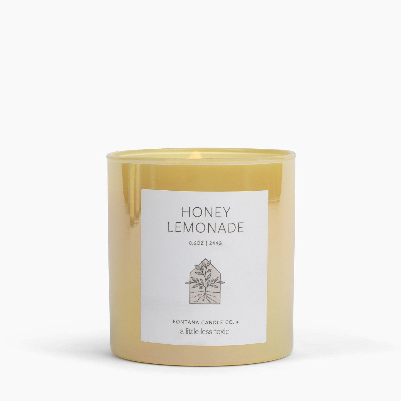 Yellow glass Honey lemonade candle with a label on a white background.