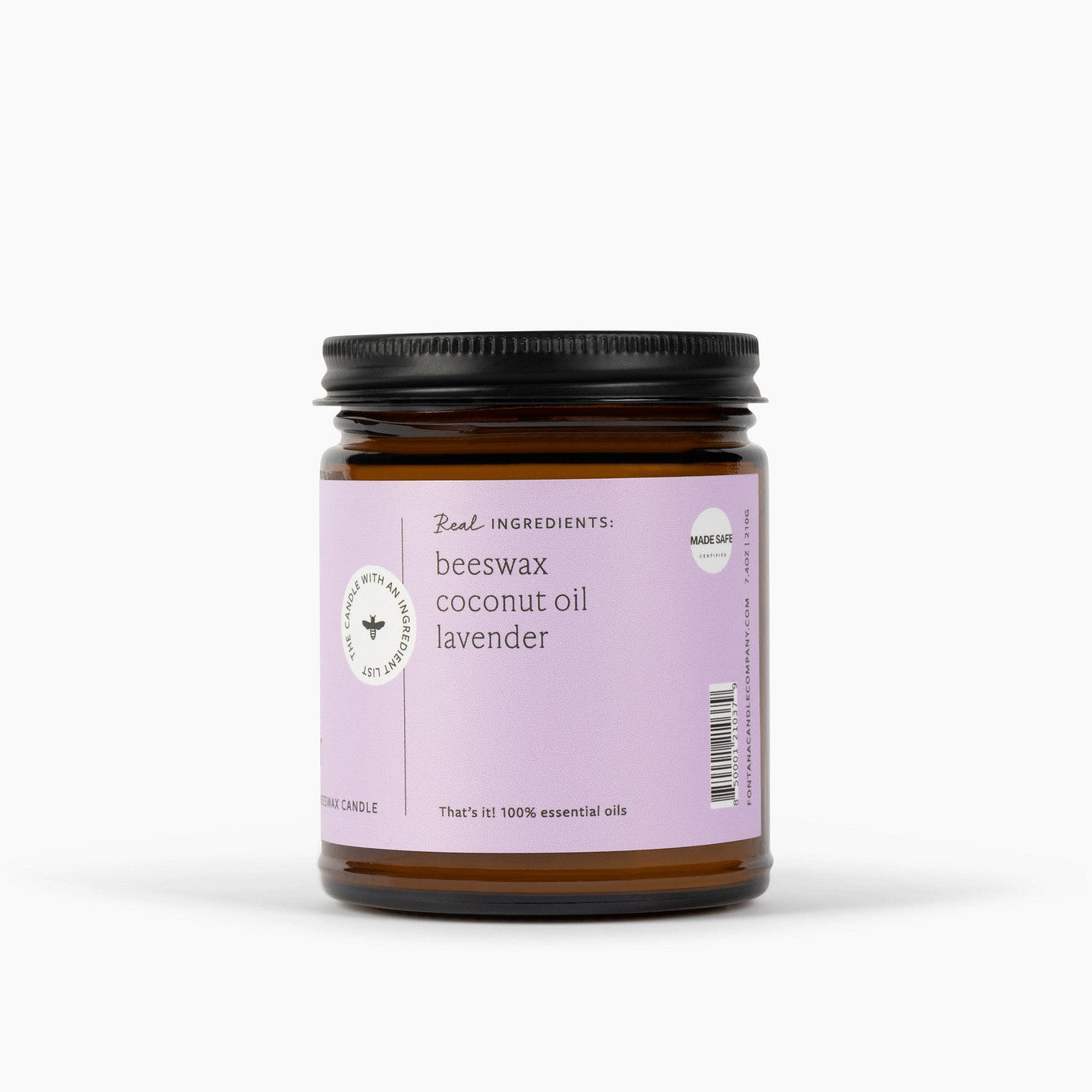 Side view of an amber glass jar candle with a black lid. The candle has a purple label and is in front of a white background. 