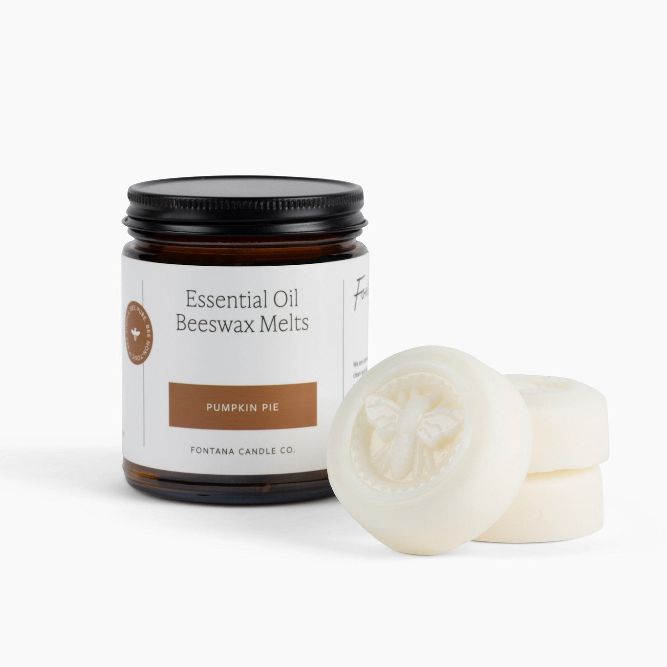 Jar of essential oil beeswax melts labeled 'Pumpkin Pie' with three off white pucks on a white background