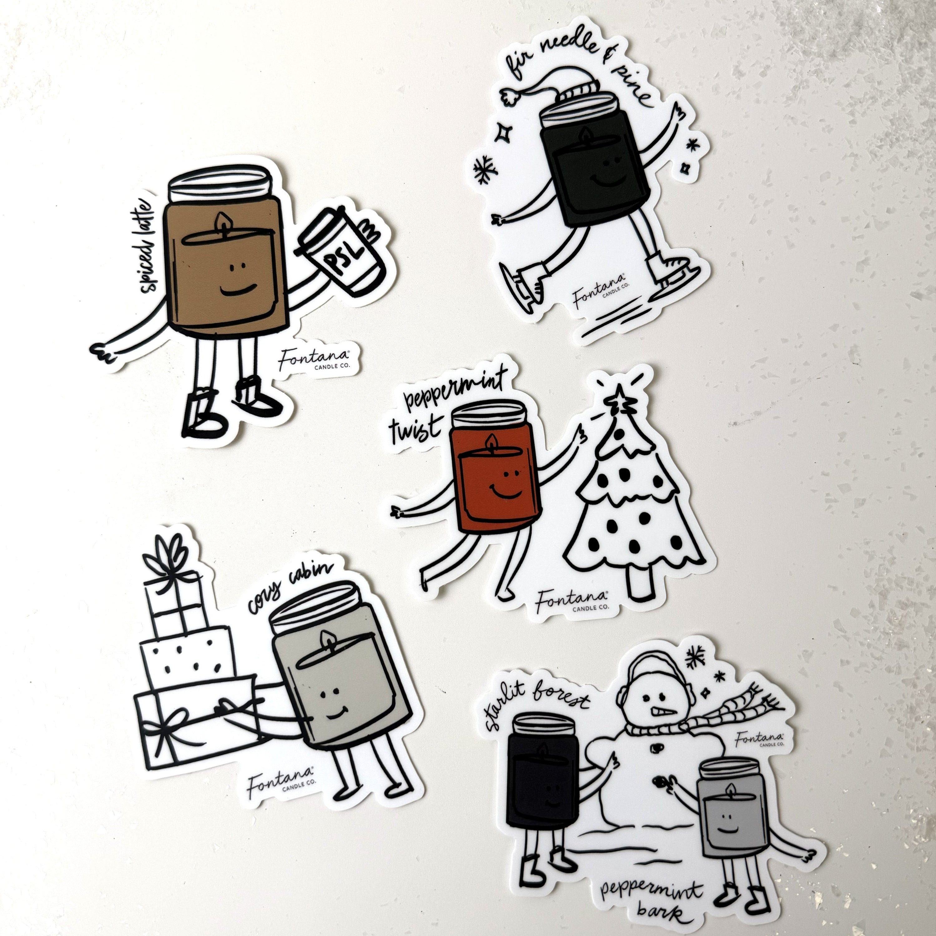 Set of illustrated candle holiday designs with faces on a textured white background.