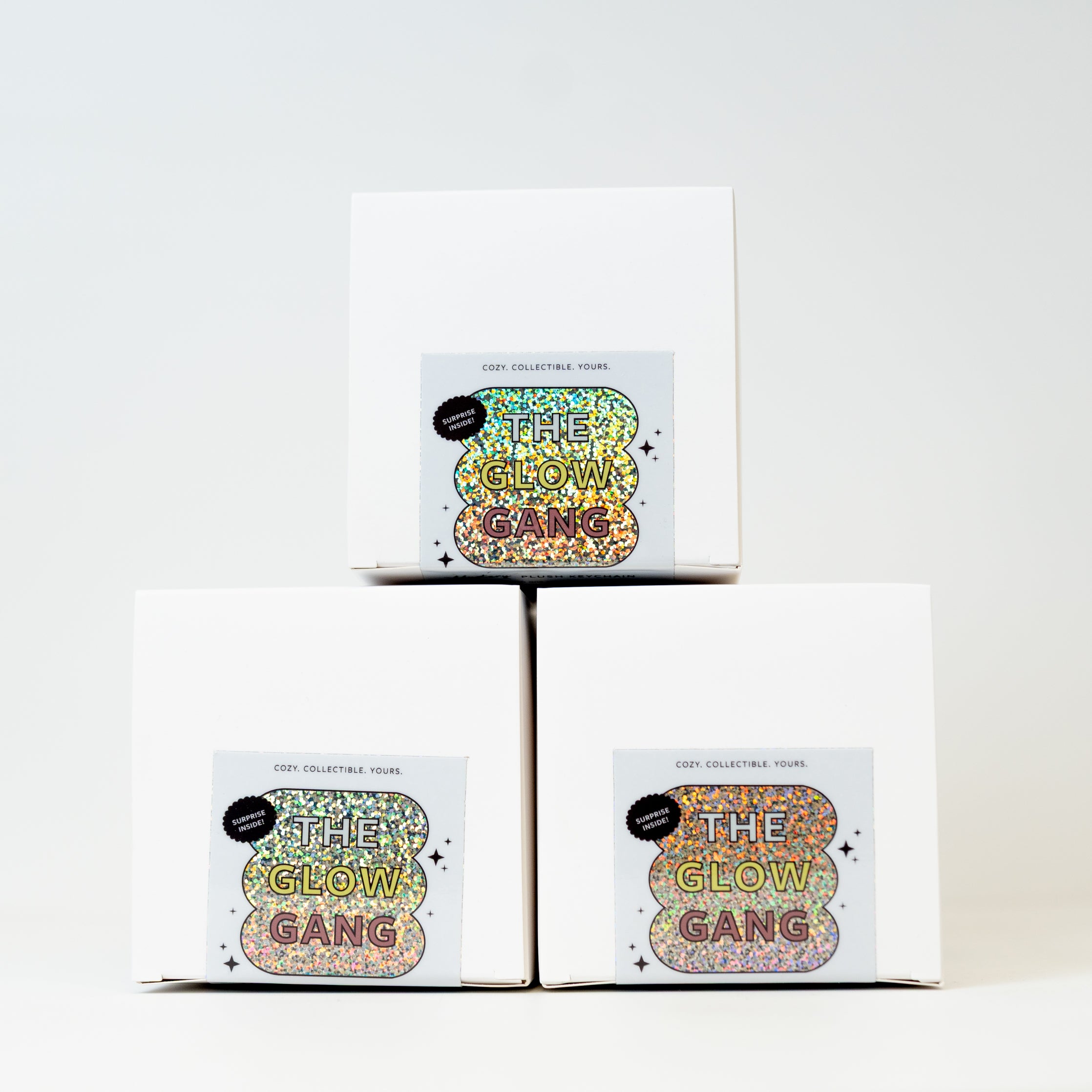 The Glow Gang candles mystery blind boxes stacked against a neutral background 