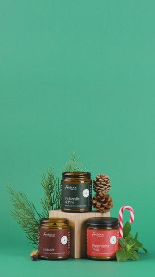 Collection of candles with natural elements on a green background
