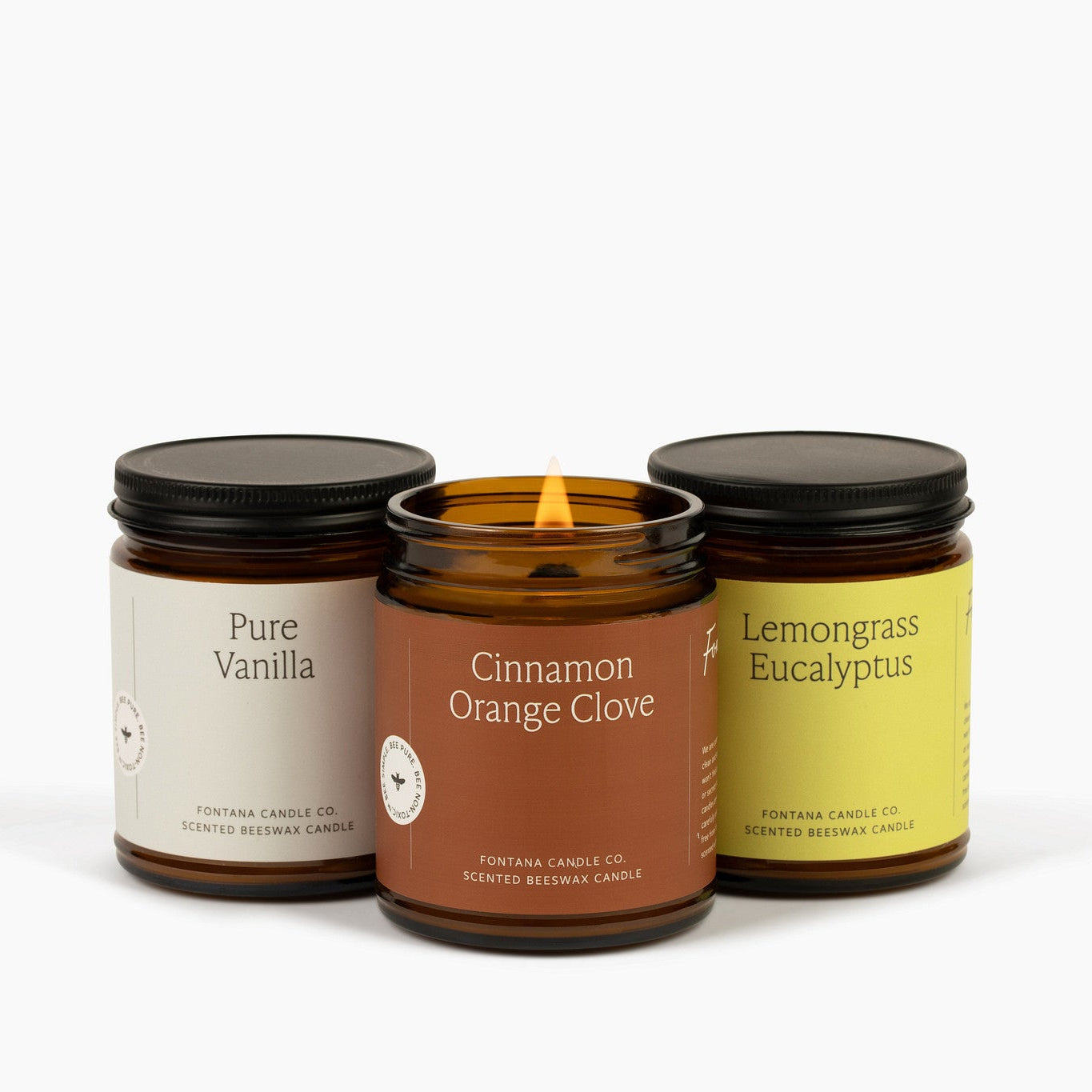 pure vanilla, cinnamon orange clove and lemongrass eucalyptus candles against a neutral background