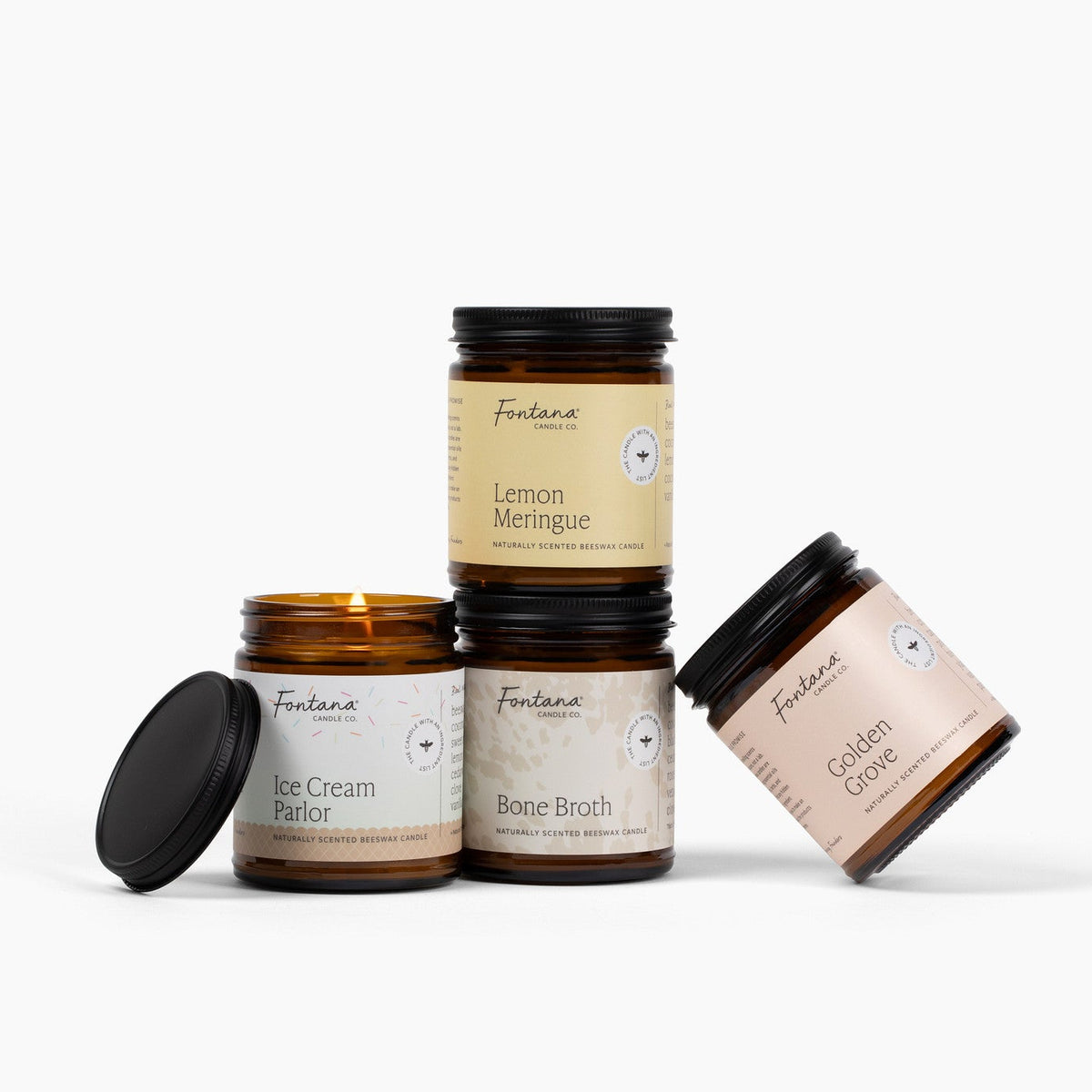 Four 9oz amber jar candles posed together, lemon meringue, ice cream parlor, bone broth, golden grove. 