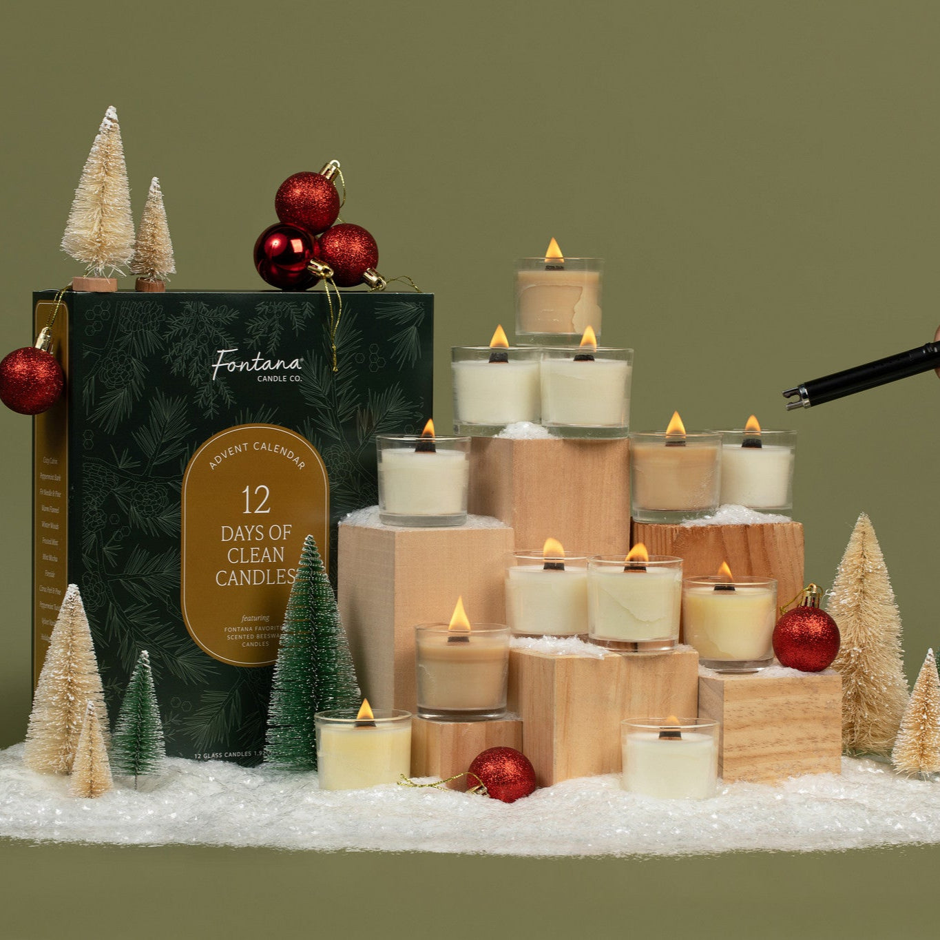 Fantana 12 Days of Clean Candles set with decorative candles and trees on a green background.