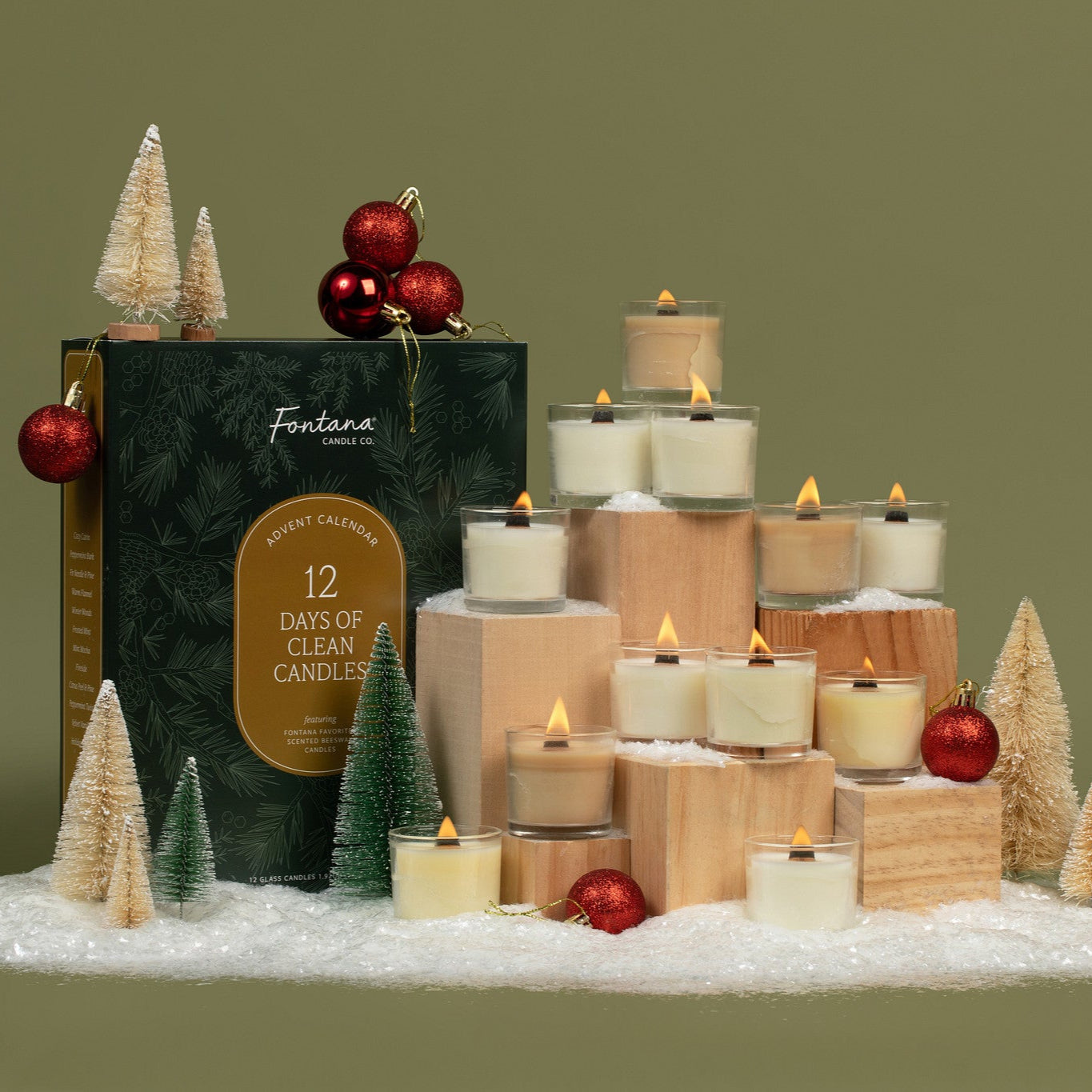 Fantana 12 Days of Clean Candles set with decorative candles and trees on a green background.