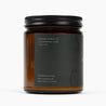 Side of amber glass jar candle with a dark green label and the scent: Fir Needle & Pine.