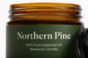 Brown glass jar with green label reading 'Northern Pine' on a white background