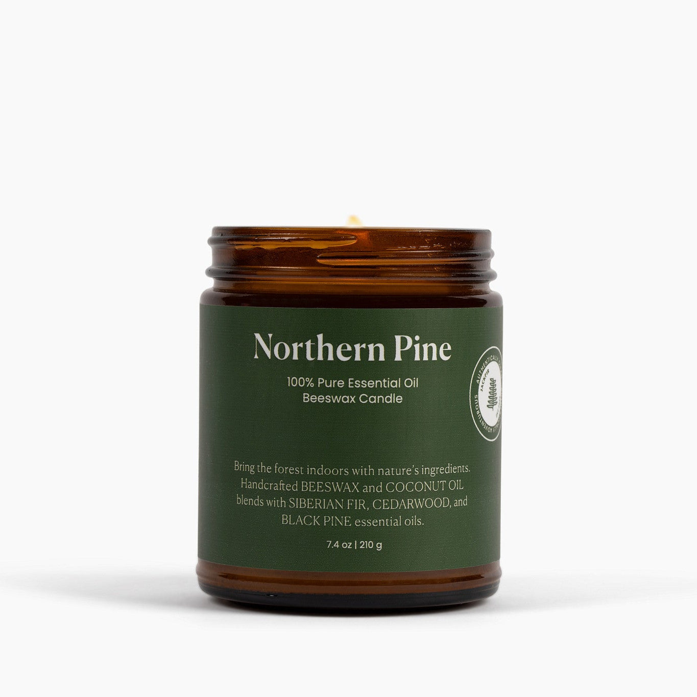 Candle in a brown glass jar labeled 'Northern Pine' on a white background
