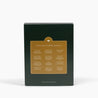 Dark green advent calendar box with gold accents highlighting the 12 scents inside. 