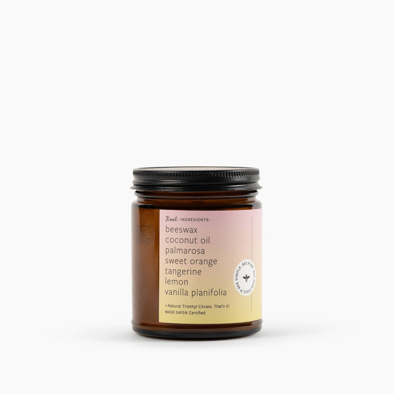 Side view of an amber glass Jar candle on a white background.