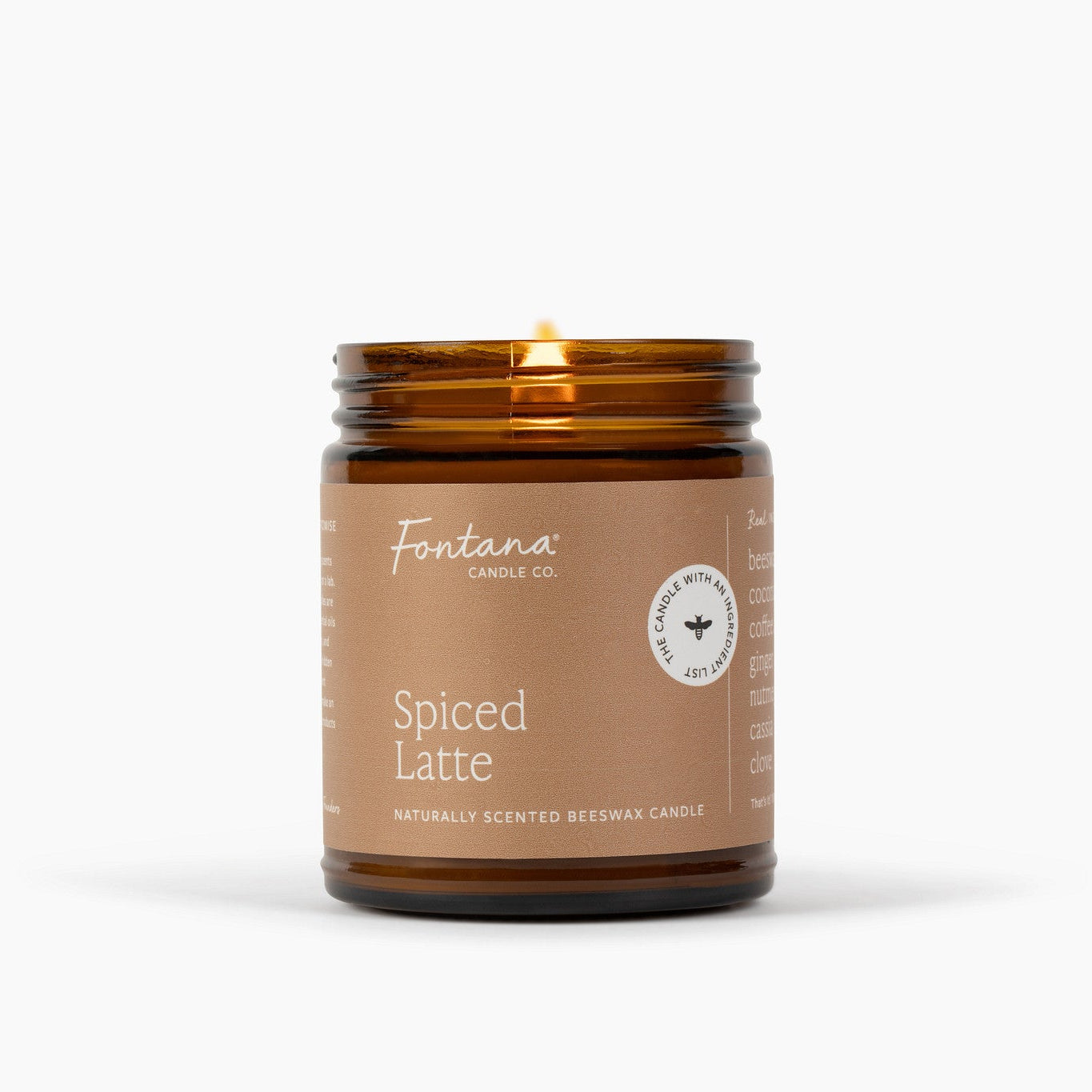 A lit amber glass jar candle with a brown label reading 'Fontana Candle Co.' and 'Spiced Latte' on a clean white background.