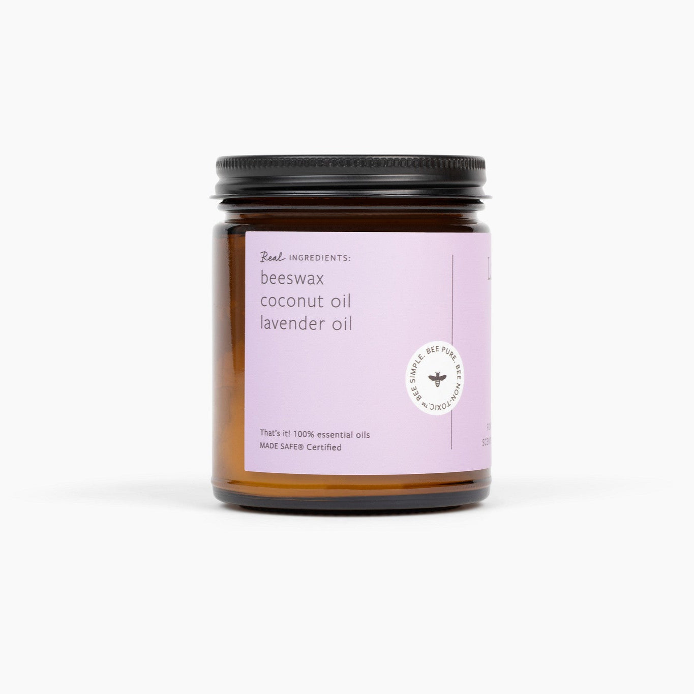 Side view of an amber glass jar candle with a black lid. The candle has a purple label and is in front of a white background. 