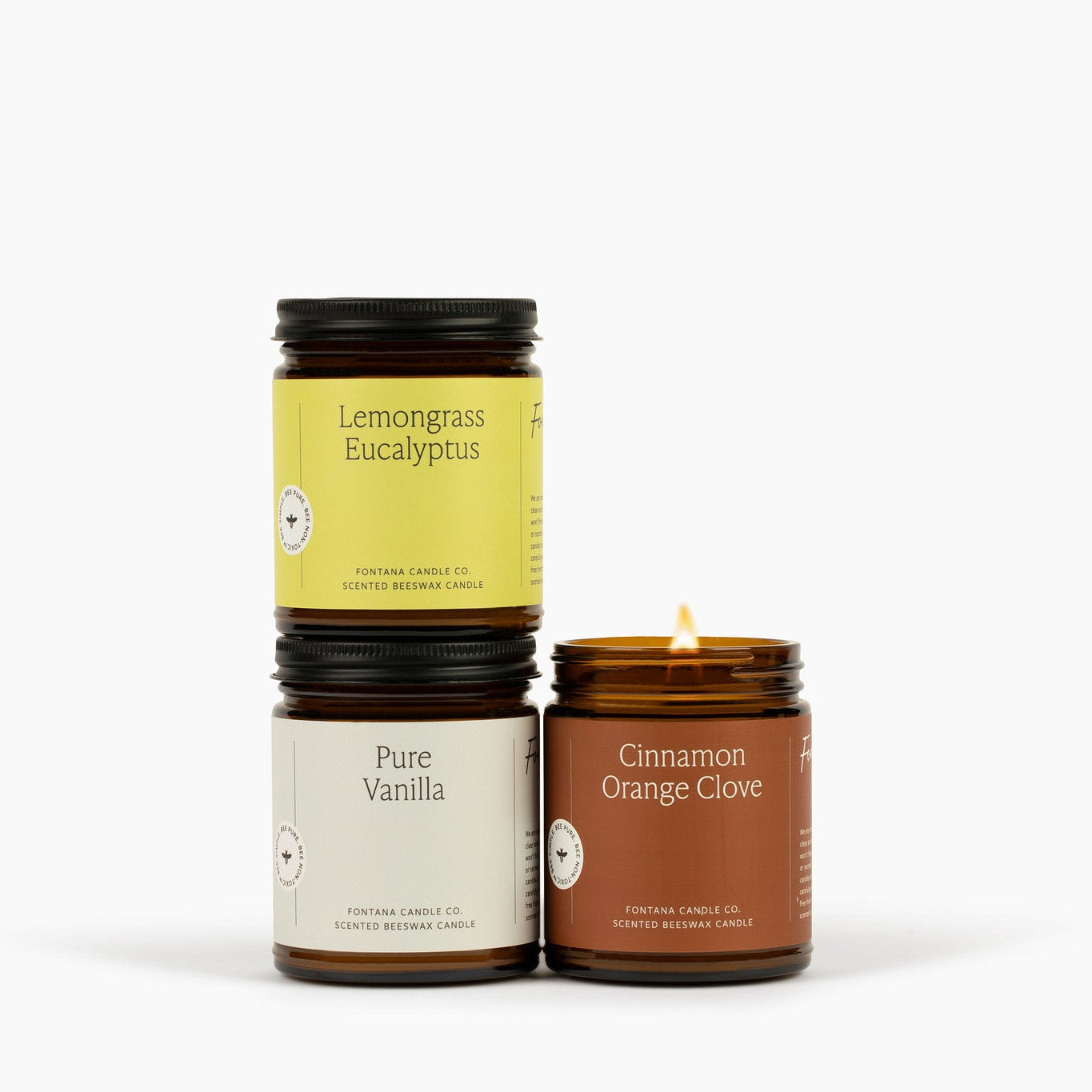 pure vanilla, cinnamon orange clove and lemongrass eucalyptus candles stacked together against a neutral background