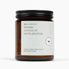 Unlit amber glass jar candle with a white label and the ingredients: beeswax, coconut oil, vanilla planifolia, and natural triethyl citrate.