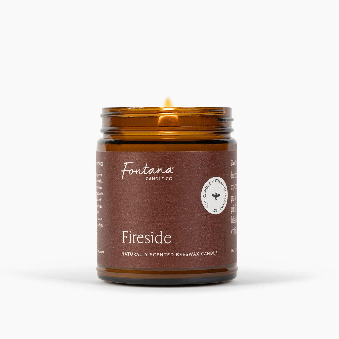 An amber glass jar candle with a brown label reading 'Fontana Candle Co.' and 'Fireside' on a clean white background.