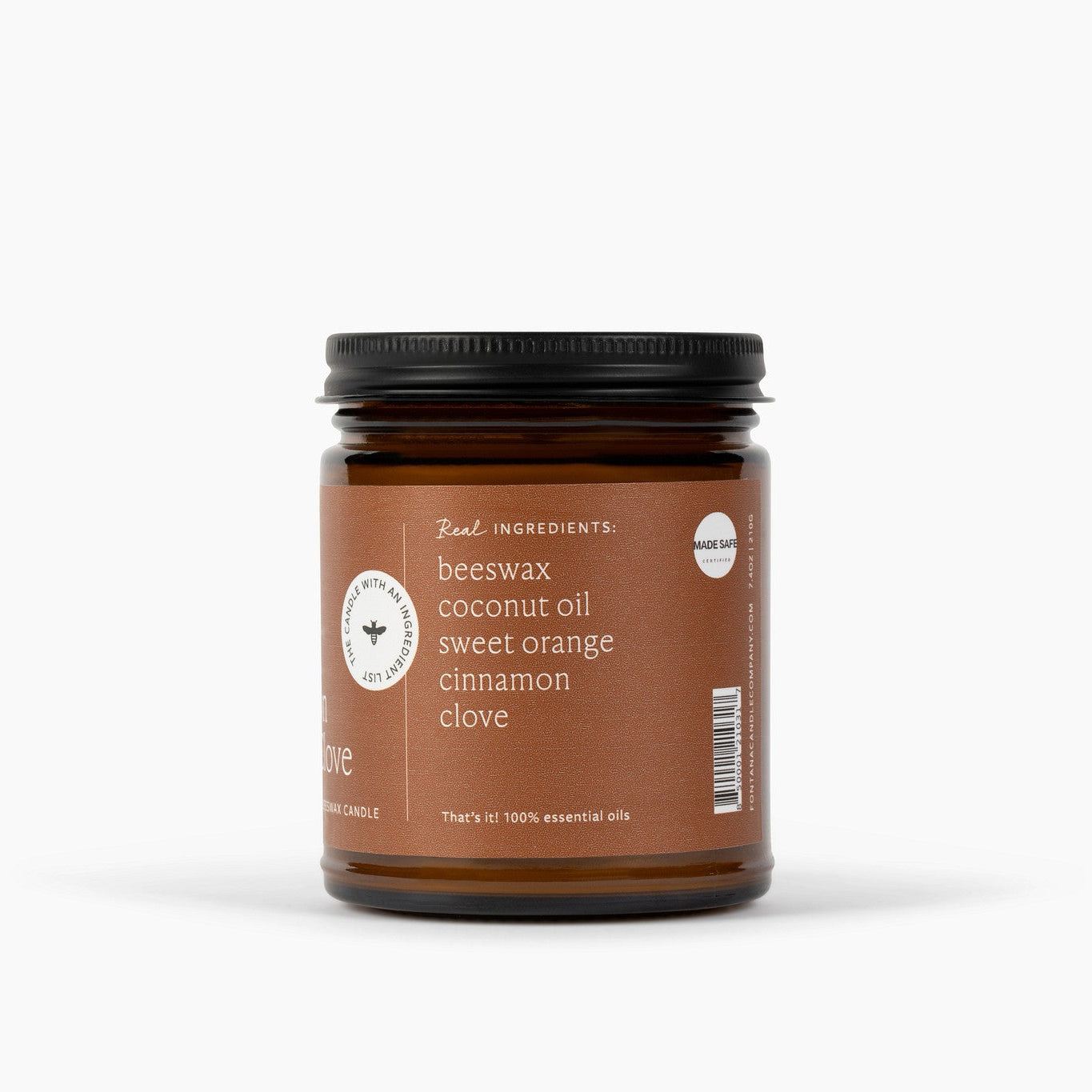A side view of an amber glass jar of beeswax coconut oil with a black lid and a brown label, featuring white text that reads 'beeswax coconut oil sweet orange cinnamon clove' on a clean white background.