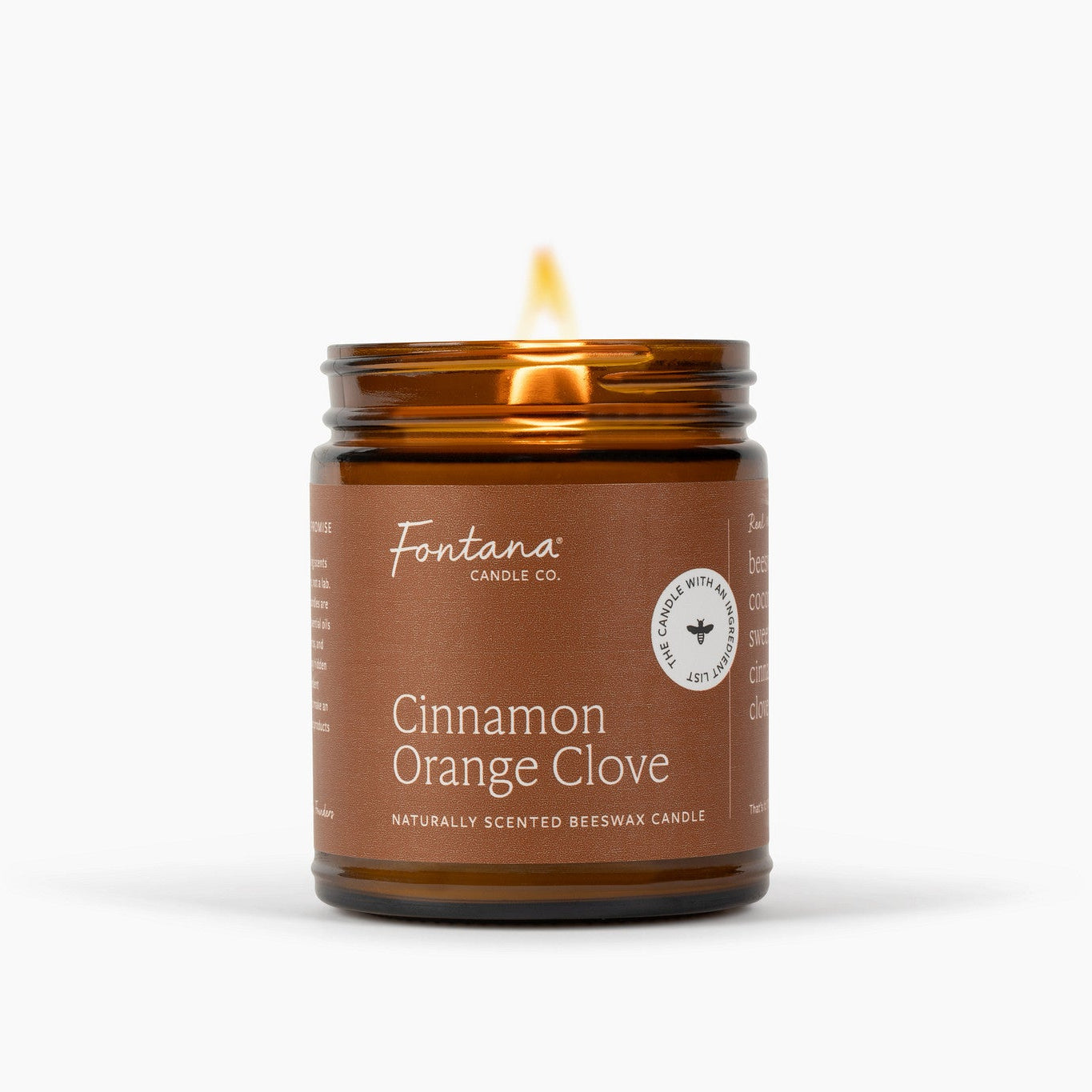 A lit amber glass jar candle labeled Fontana Candle Co. Cinnamon Orange Clove, shown on a clean white background with a soft shadow.