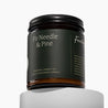 Amber glass jar candle with a green label. It is labeled 'Fir Needle & Pine' by Fontana Candle Co. on a white background