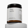 Amber glass jar candle with a white label and Pure Vanilla on front of a white background.