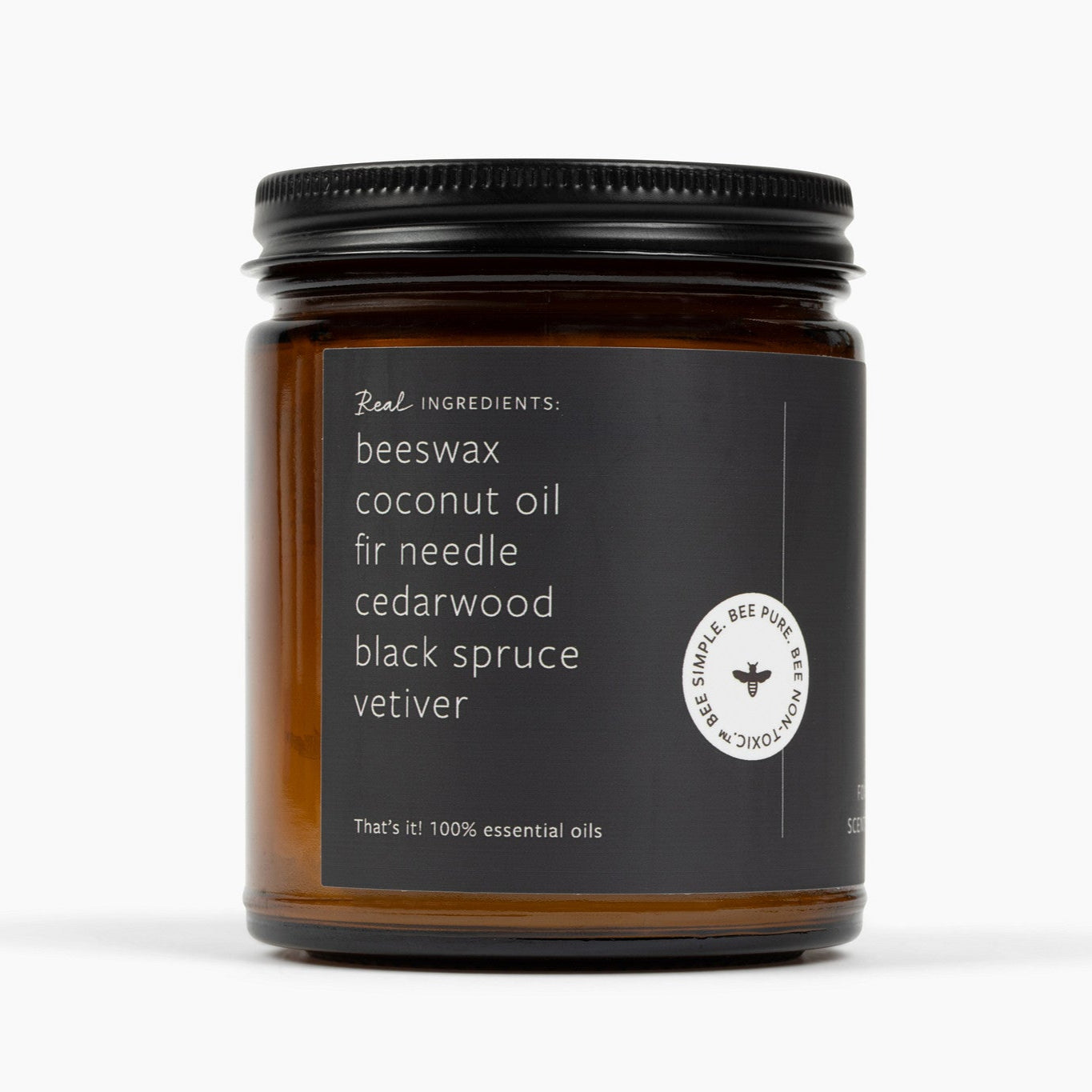 Side shot of an Amber glass candle jar with a dark green label showing the ingredients: beeswax, coconut oil, fir needle, cedarwood, black spruce, and vetiver. 