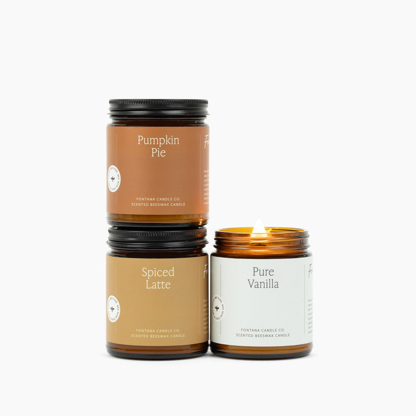 Three amber jar candles on a white background: Pumpkin Pie, Spiced Latte, and Pure Vanilla. 
