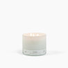 Lit 3 wick candle burning in a white glass container with a Fireside scent label. 
