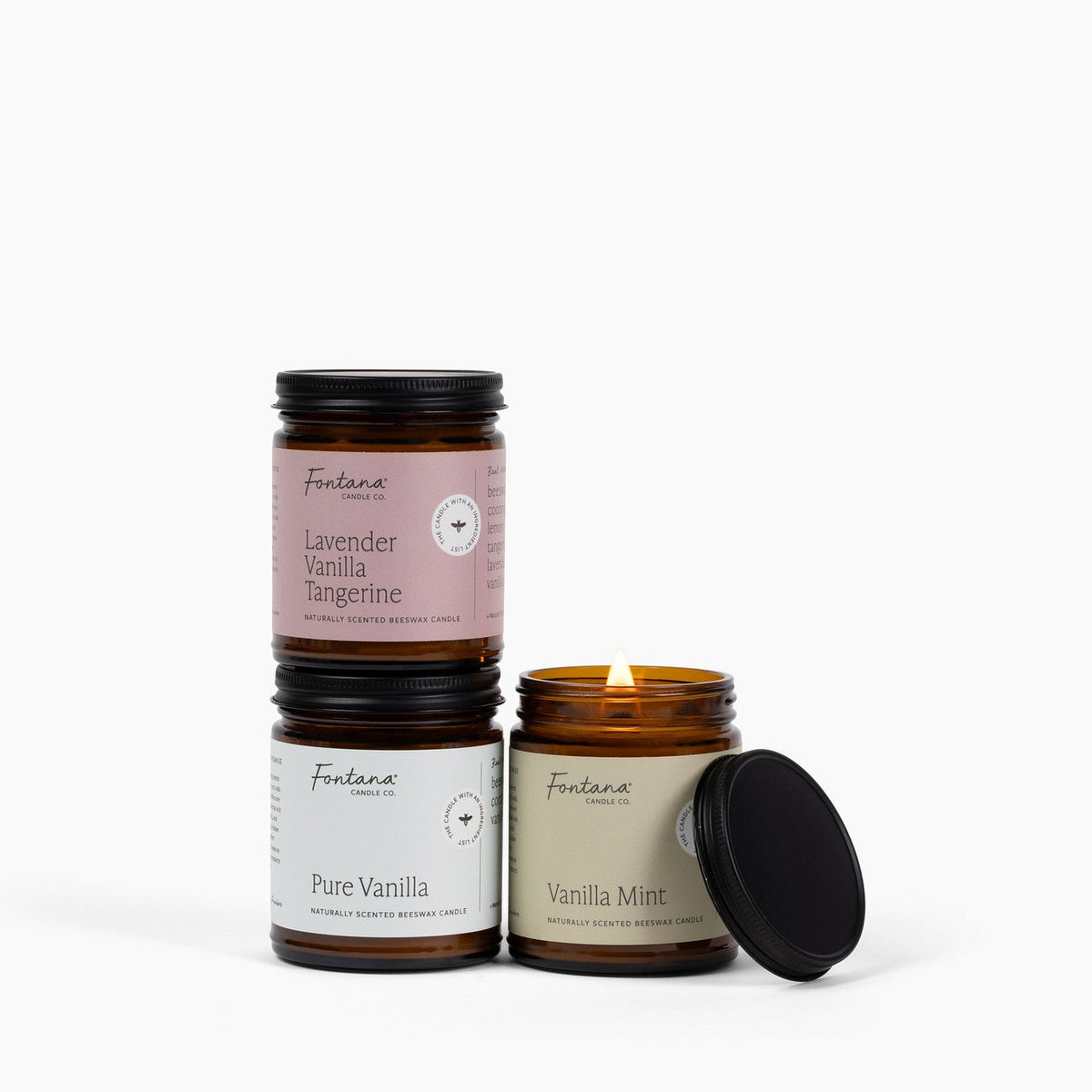 Lavender Vanilla Tangerine, Pure Vanilla, Vanilla Mint 9oz jar candles posed together on a white background. 