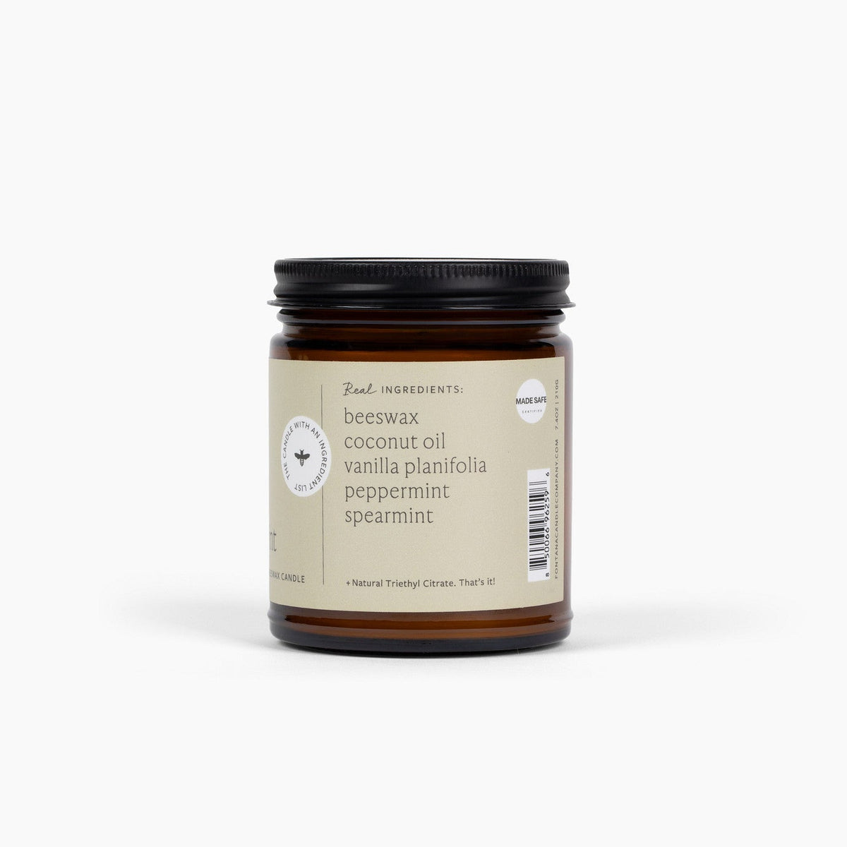 side view of the vanilla mint 9oz jar candle, showing the ingredients in the candle